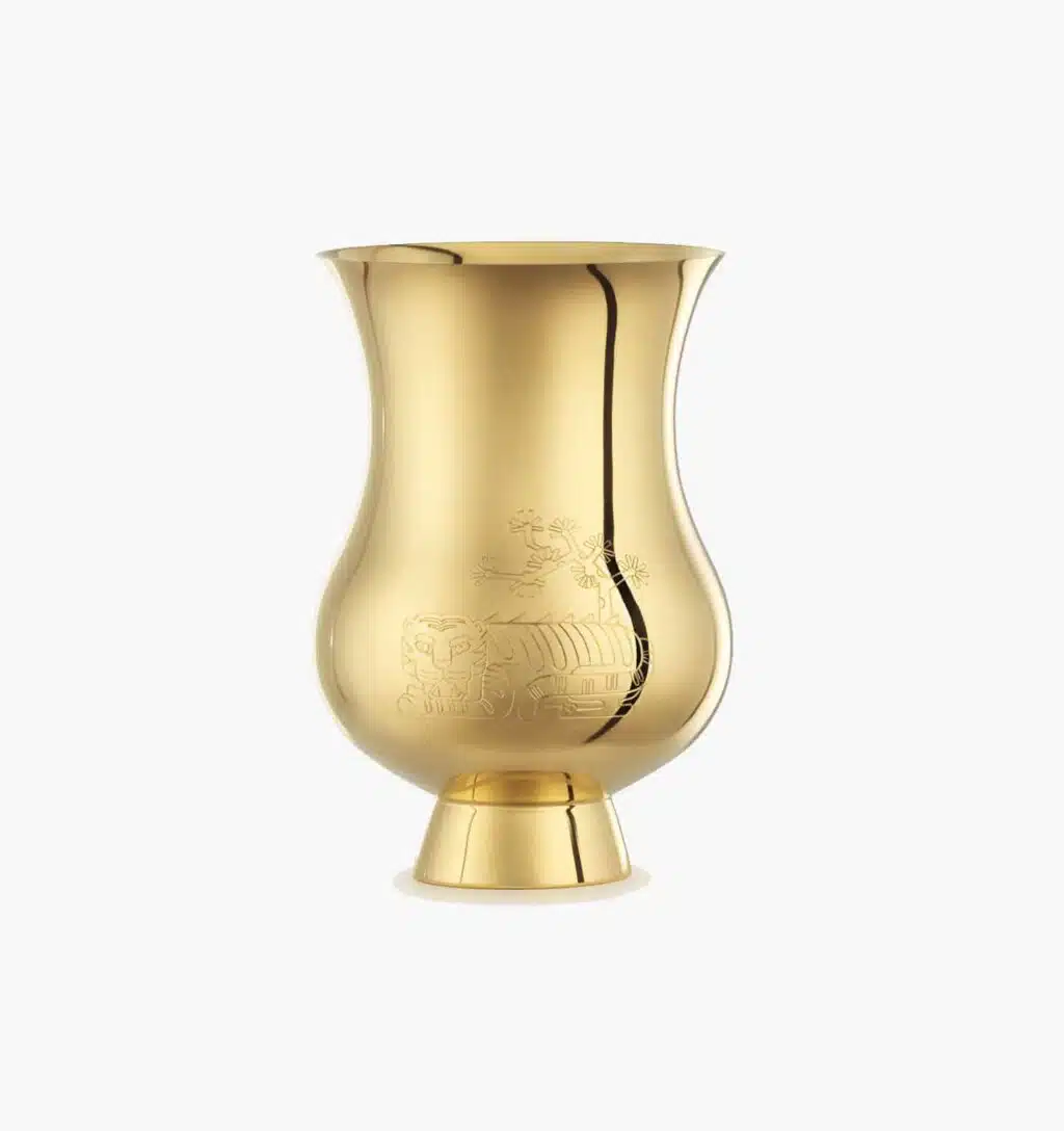 Timpani engraved with the zodiac sign of the "Year of the Tiger" in vermeil from the Pour le champagne collection by Puiforcat on a light background.