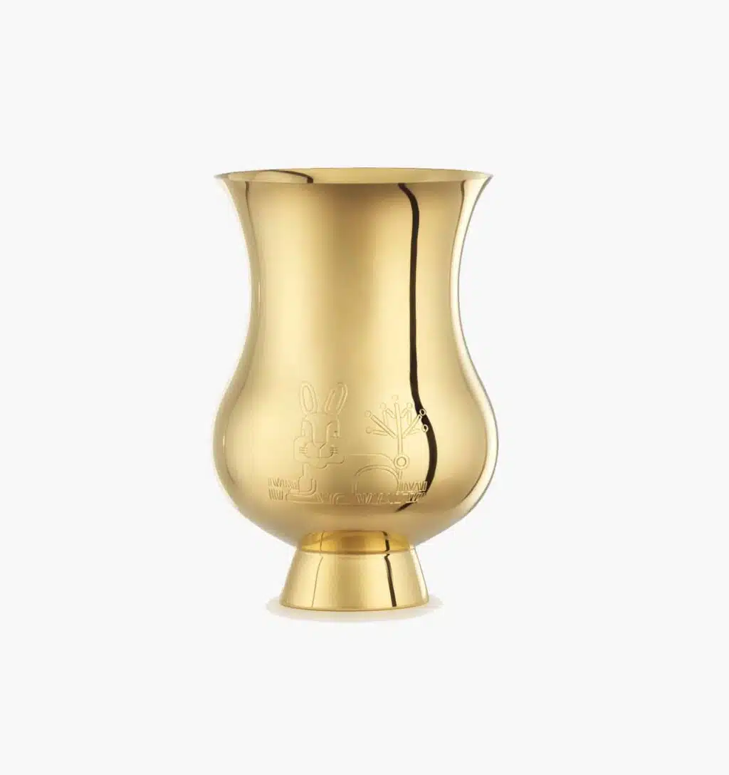 Tumbler engraved with the zodiac sign of the "Year of the Rabbit" in vermeil from the Pour le champagne collection by Puiforcat on a light background.